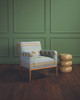 Woven Ribbon Aqua upholstered on a chair in a green room